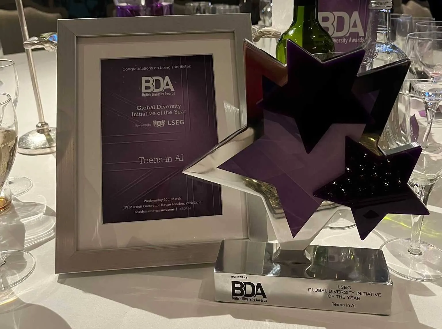 The British Diversity Awards 2024 trophy for Global Diversity Initiative of the Year, engraved Teens in AI, beside the shortlist certificate